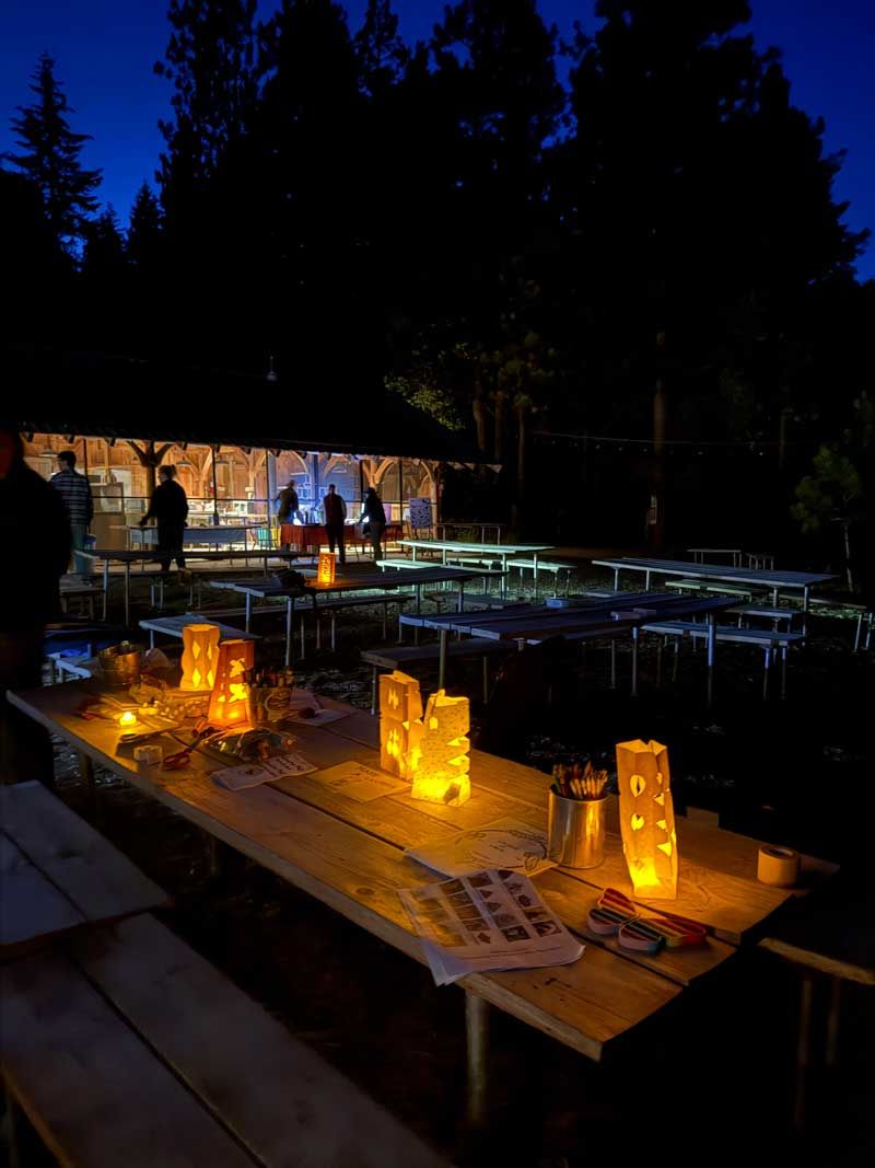 The Crest campground set up for Moth Night event with luminaria on picnic tables