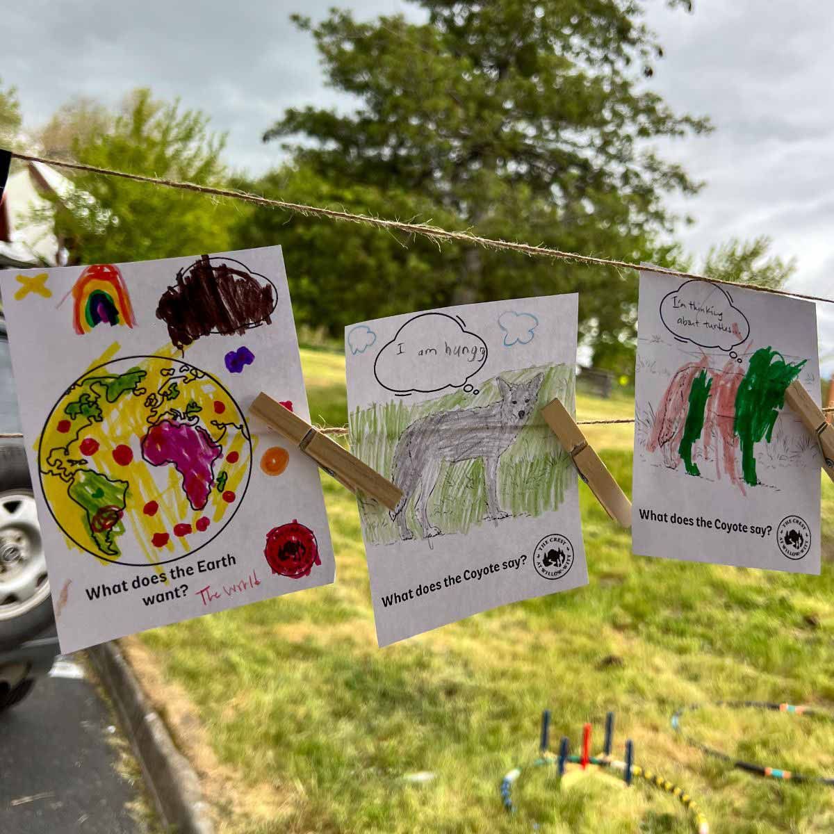 children's colored drawings at The Crest's Earth Day event booth