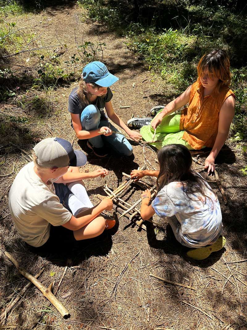 Nature Day Camp participants proudly display their teepee style campfire