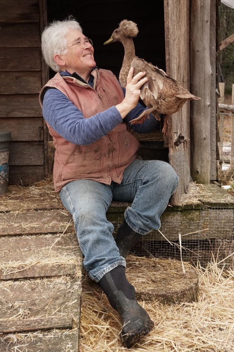 Dr. Lanita Witt smiles as she holds a duck at Willow-Witt Ranch barn