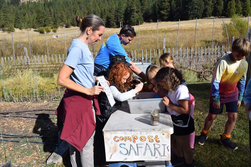 staff educating children about compost