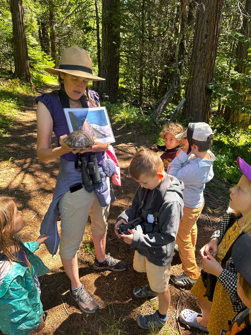Education Director Liz talks to group of students on trail about western pond turtles