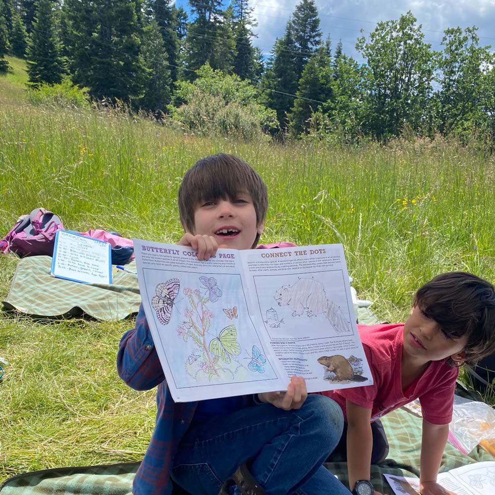 Nature Day Camp camper shows his nature drawings