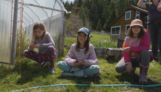 Young girls sit on the lawn while participating in an educational program at The Crest at Willow-Witt Ranch.