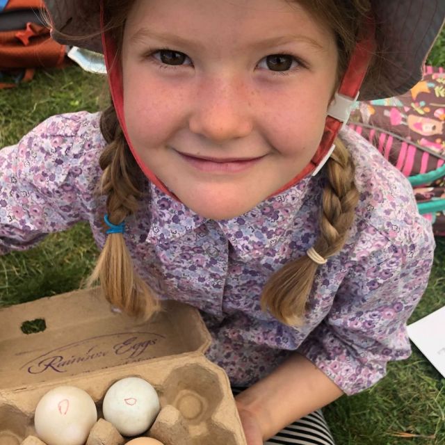 smiling summer camp child gathering eggs