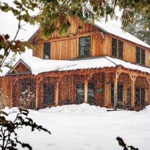 Meadow House farm stay vacation rental blanketed in winter snow